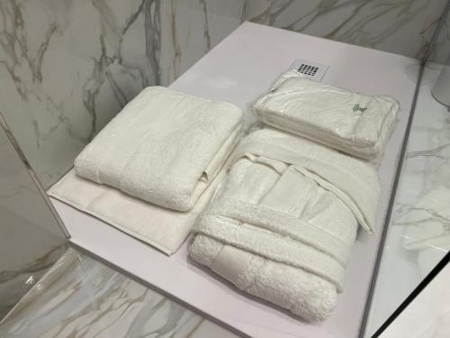 two white towels on a table in a bathroom at CUORE - LUXURY ROOMS in Pescara