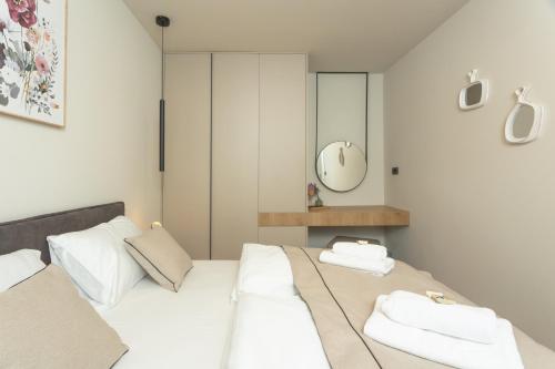 a bedroom with two beds and a mirror at Maris Villas in Zaboric