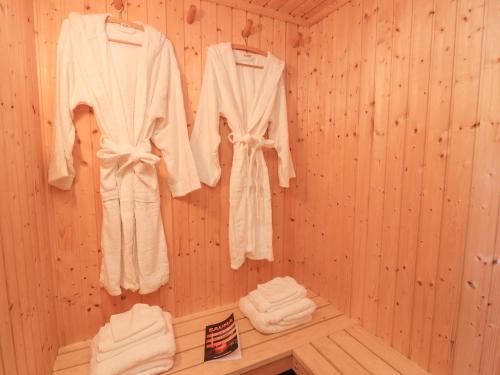 a room with white robes hanging on a wall at Creed Cabin in Stornoway