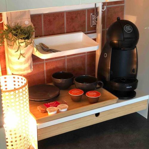 a kitchen counter with a coffee maker and some food at Studio Zeezucht in Blankenberge