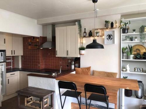 a kitchen with a wooden table and some chairs at Studio Zeezucht in Blankenberge