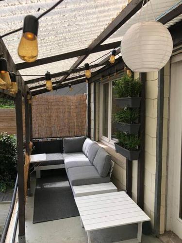 a pergola with two benches on a patio at Studio Zeezucht in Blankenberge