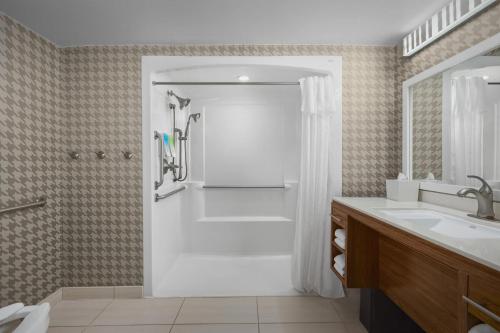 a bathroom with a shower and a sink at Home2 Suites by Hilton Jacksonville, NC in Jacksonville