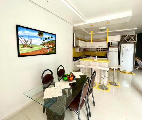a kitchen with a glass table and chairs and a kitchen with at Bela Casa Hostel in Ji-Paraná