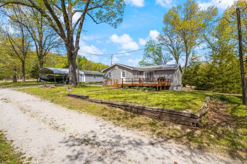 a large house with a porch next to a dirt road at Eternal Sunrises in Sunrise Beach