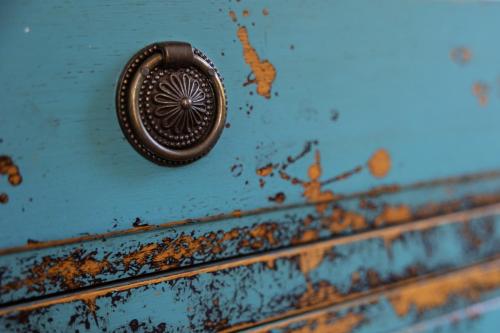 a close up of a blue dresser with a metal knob at Le Moulin de Mitou in Auriac-du-Périgord
