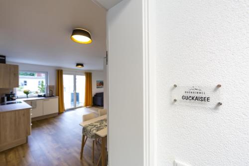 a kitchen and living room with a door with a sign on it at Ferienwohnungen Rhönhimmel in Gersfeld