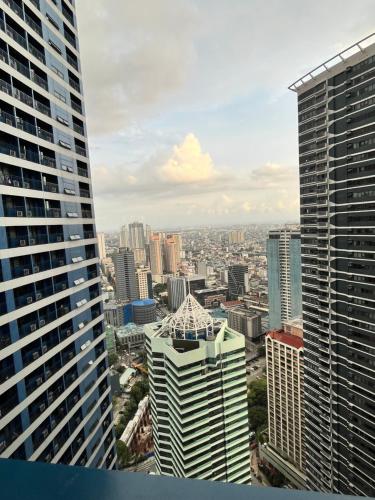 a view of a city skyline from a skyscraper at Air Residences Airbnb in Manila
