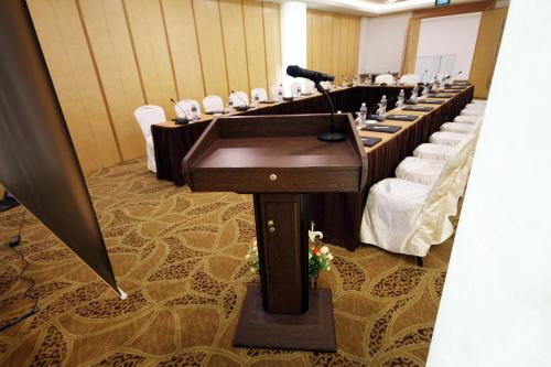 a conference room with a microphone in the middle at Badi'ah Hotel in Bandar Seri Begawan
