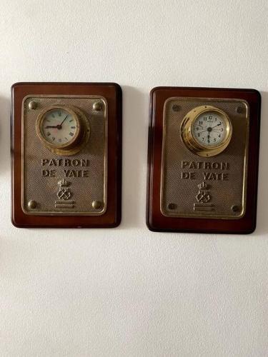 two clocks are sitting on top of a wall at La Digue Beach House in San Vicente de Calders