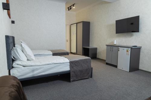 a hotel room with a bed and a television at THE TIME HOTEL in Tashkent
