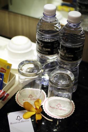 a table with two bottles of water and two empty glasses at Badi'ah Hotel in Bandar Seri Begawan