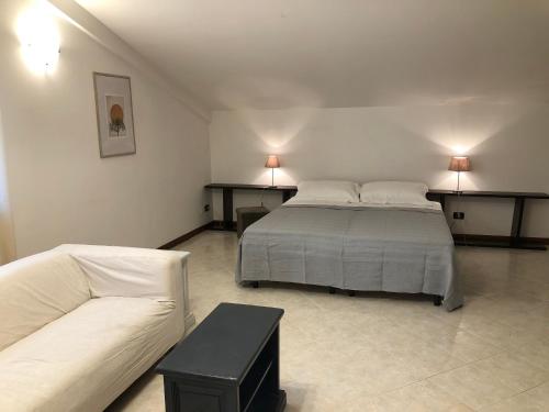 a bedroom with a bed and a couch at Hotel Kristall in Orvieto