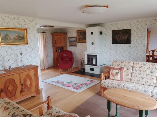 a living room with a couch and a table at Gladsax Gamla Gård in Simrishamn