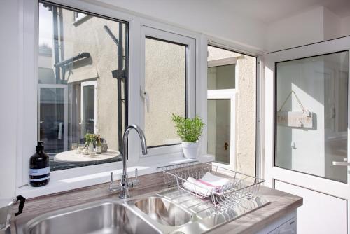 a kitchen with a sink and a window at York Cottage in Sidmouth