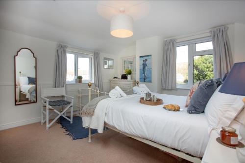 a bedroom with a large bed and a mirror at York Cottage in Sidmouth