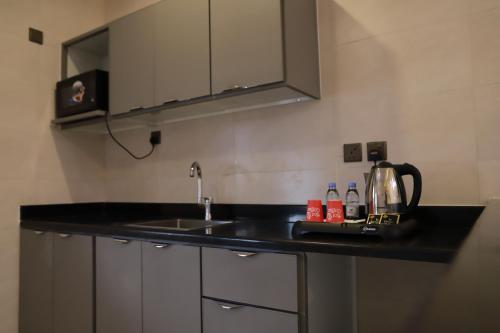 a kitchen with a sink and a counter top at Diaara Hotel Appartments in Khamis Mushayt