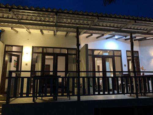 a house with a balcony with a table on it at Mandy House in Habaraduwa