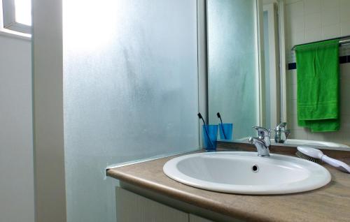 y baño con lavabo blanco y espejo. en VVF Sigean Port-la-Nouvelle Corbières, en Sigean