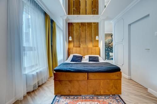 a bedroom with a bed with a wooden headboard at Jacuzzi EnergyApart in Szczecin