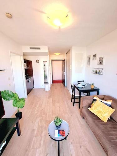 un salon avec un canapé et une table dans l'établissement Le Valmy: appartement lumineux au pied du métro, à Lyon