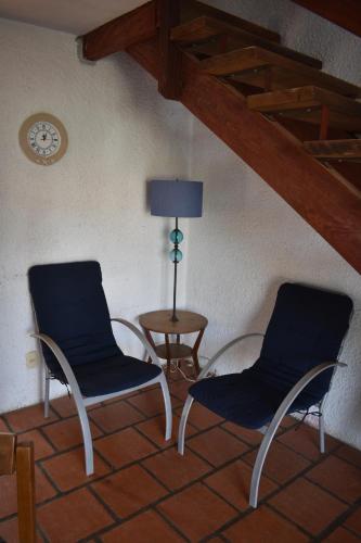 two chairs and a table and a lamp in a room at Brisas del Diablo 2 in Punta Del Diablo
