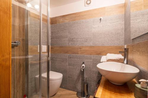 a bathroom with a sink and a toilet and a shower at Residence Covalou in Antey-Saint-André