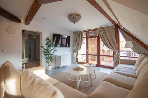 a living room with a couch and a table at ApartOne Altstadt-Hotel in Bautzen