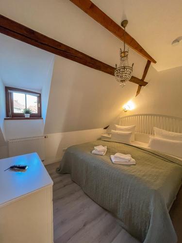 a bedroom with a large bed and a window at ApartOne Altstadt-Hotel in Bautzen