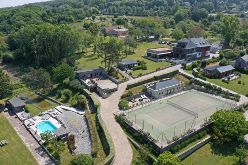 an aerial view of a mansion with a tennis court at Domaine du Grand Bec in Villerville