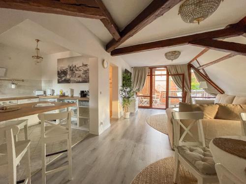 a kitchen and living room with a couch and a table at ApartOne Altstadt-Hotel in Bautzen