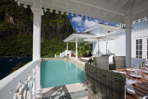 a house with a swimming pool and a patio at Sugar Beach, A Viceroy Resort in Soufrière