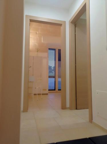 an empty room with a door leading to a kitchen at STRADONE 132 in Gravina in Puglia