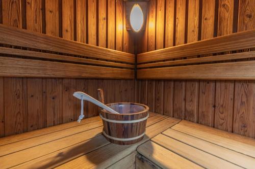 a inside of a sauna with a bucket at City Hotel Miskolc in Miskolc