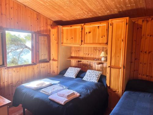 a bedroom with a bed in a wooden cabin at Villaggio Smeraldo in Moneglia