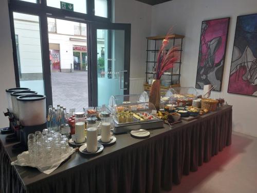 a table with a buffet of food on it at Velotel Bad Saarow in Bad Saarow
