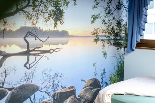 a view of a lake from a bedroom window at Luxuriöse Villa Romantica in Gampel