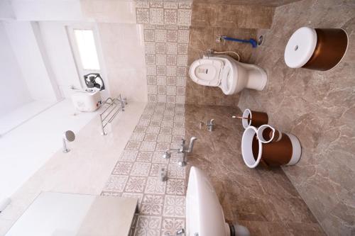 a bathroom with a sink and a toilet in it at The Hook BnB, Port Blair in Haddo