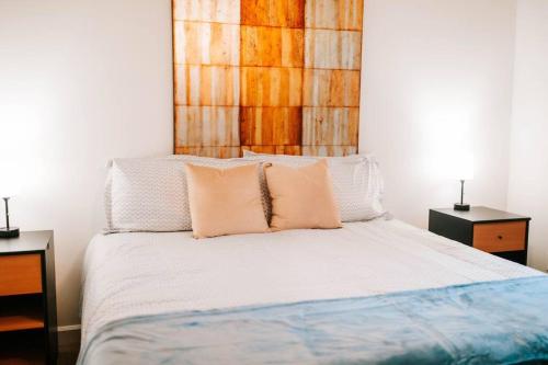 a bedroom with a bed with two pillows on it at Cozy 3-Bed Athens Getaway, Right Near UGA! in Athens