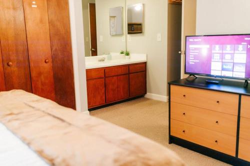 a bedroom with a bed and a television on a dresser at Cozy 3-Bed Athens Getaway, Right Near UGA! in Athens