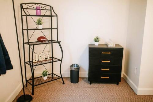 a room with a dresser and a shelf with potted plants at Cozy 3-Bed Athens Getaway, Right Near UGA! in Athens