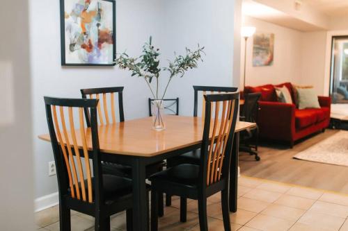 a dining room table with chairs and a vase with flowers at Cozy 3-Bed Athens Getaway, Right Near UGA! in Athens