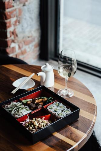 a tray of food and a glass of wine on a table at Hotel Place D'Armes in Montréal