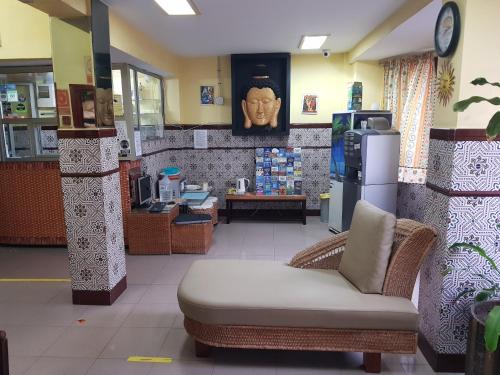 a store lobby with a chair and a refrigerator at Hostal 7 Soles in Las Palmas de Gran Canaria