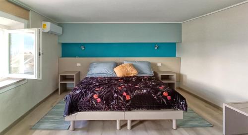 una camera da letto con un letto con una parete blu di La Romantica a Feriolo