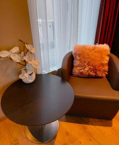 a table and a chair with a table and a table sidx sidx sidx at Mezonvin in Antwerp