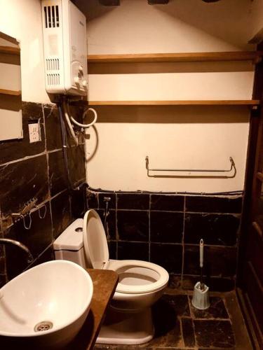 a bathroom with a white toilet and a sink at Traditional Nepali Style 1 BHK Apartment 4, Humble Home, Patan in Pātan