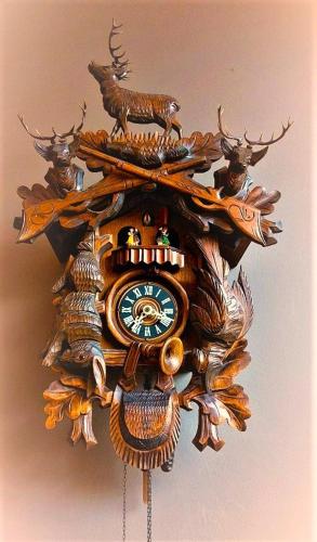 a wooden clock with deer on a wall at Mezonvin in Antwerp