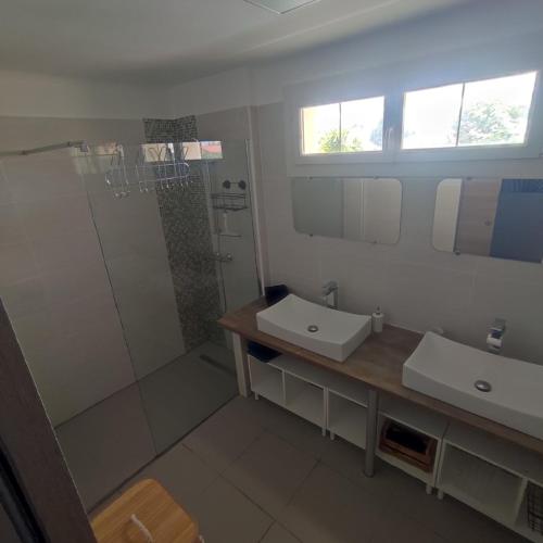 a bathroom with two sinks and a shower at Villa Eden in Latour-Bas-Elne