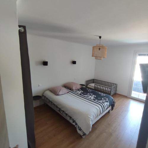 ein Schlafzimmer mit einem Bett in einem Zimmer mit einem Fenster in der Unterkunft Villa Eden in Latour-Bas-Elne